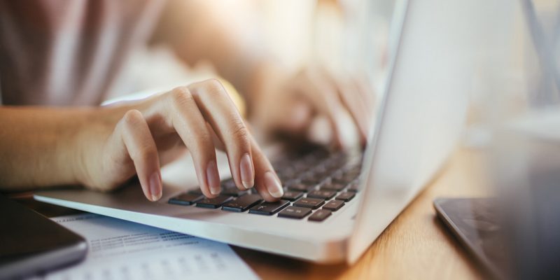 Close up of a woman using a laptop